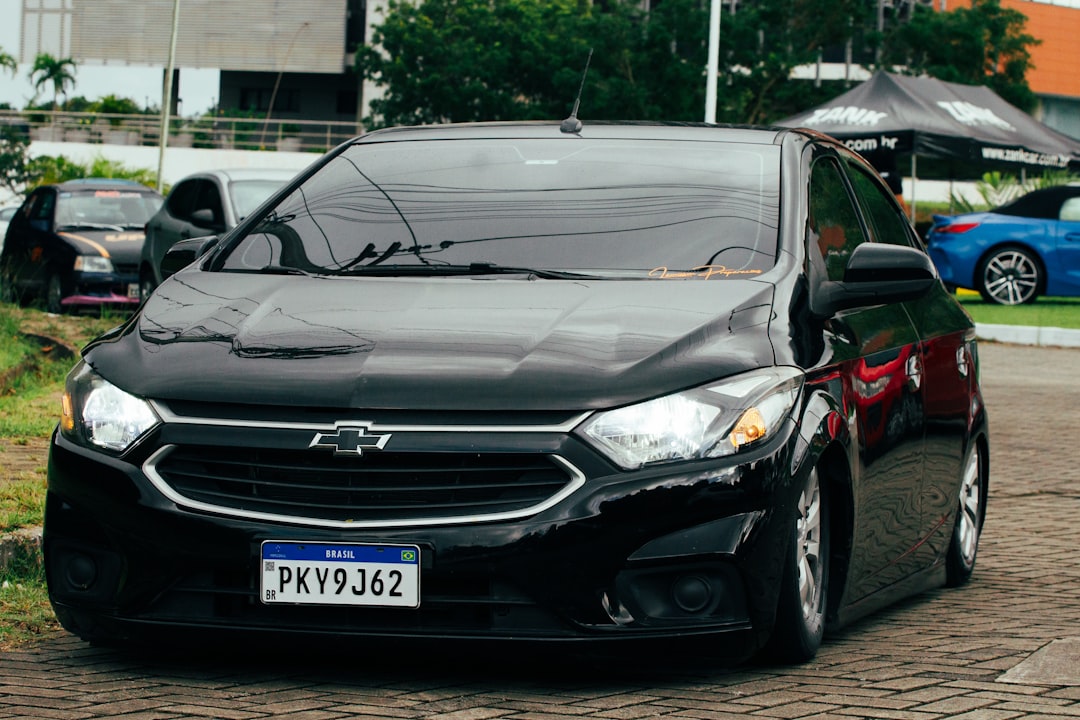 A black car parked in a parking lot